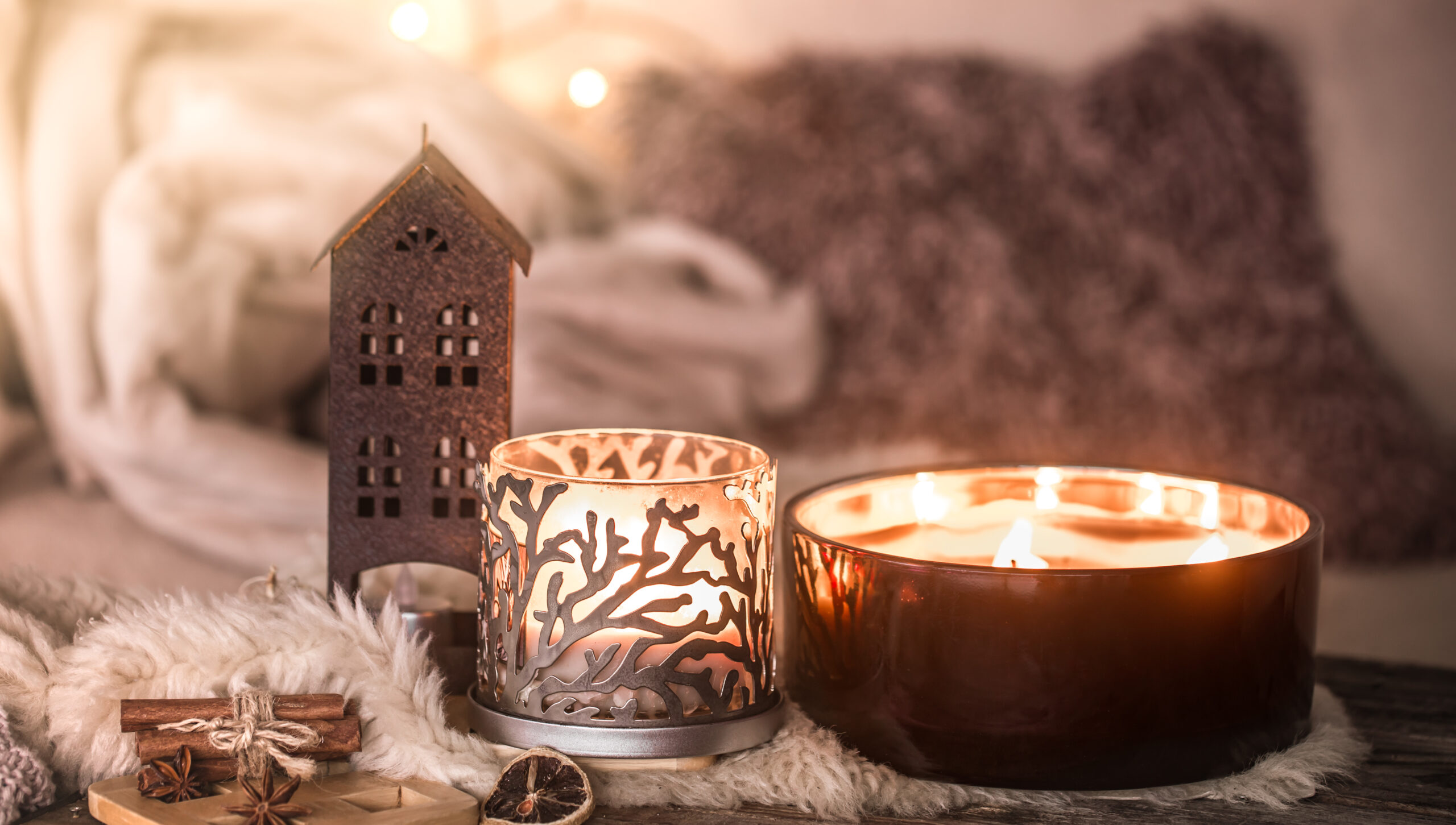 home still life in the interior with beautiful candles, on the background of a cozy home decor, the concept of home items