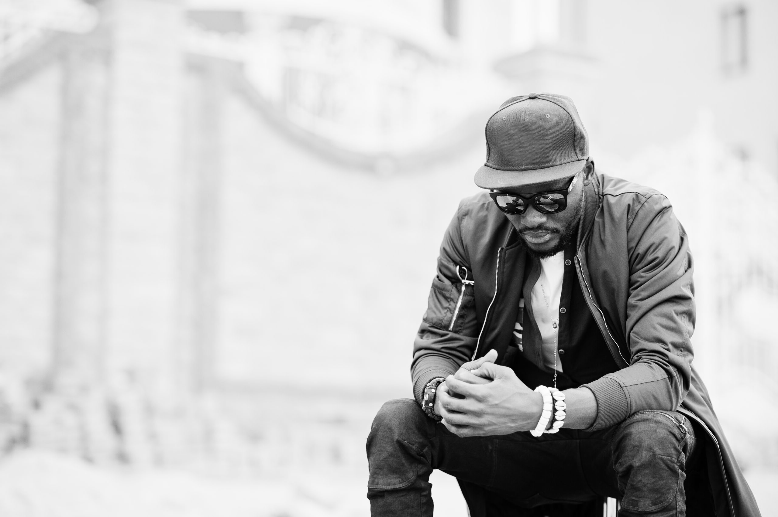 Close up portrait of stylish african american man wear on sunglasses and cap outdoor. Street fashion black man.