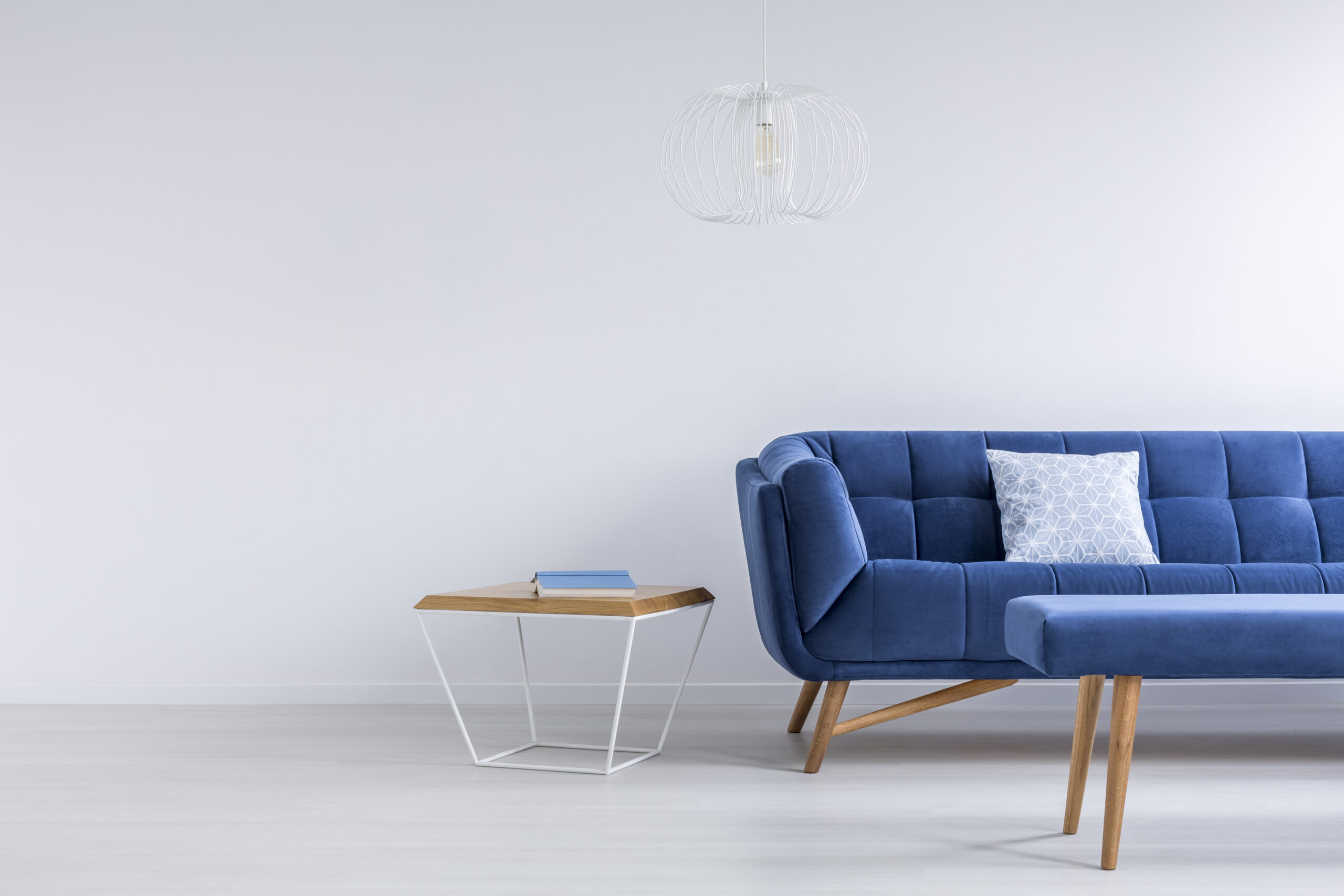 Blue sofa and bench in white trendy lounge